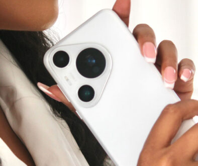 a woman holding a white cell phone
