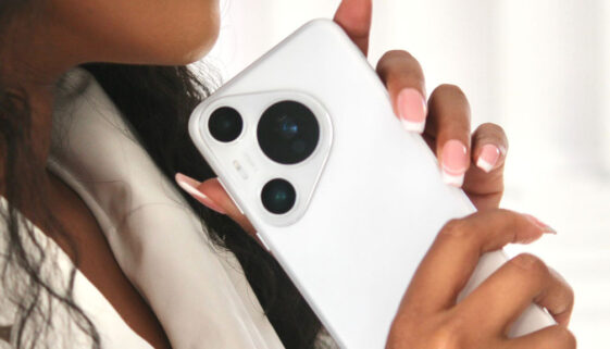 a woman holding a white cell phone