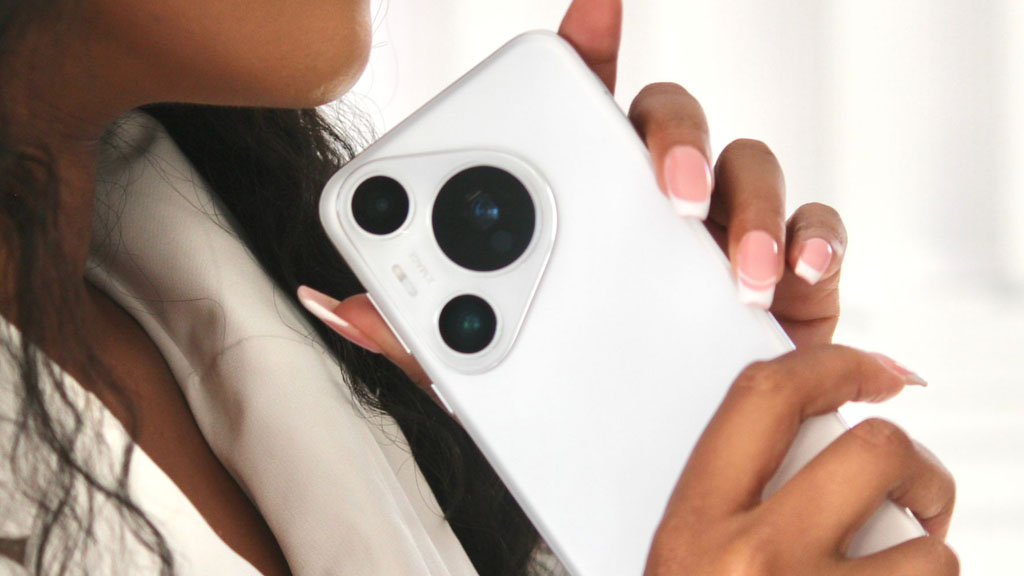 a woman holding a white cell phone